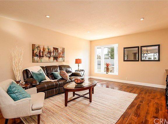 Living room with seated bay window.