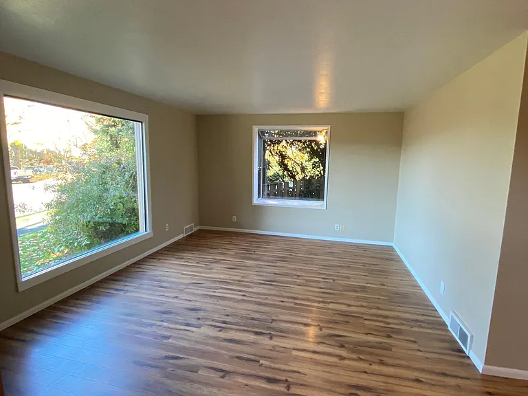 Front room with large picture window and garden window looking into the backyard