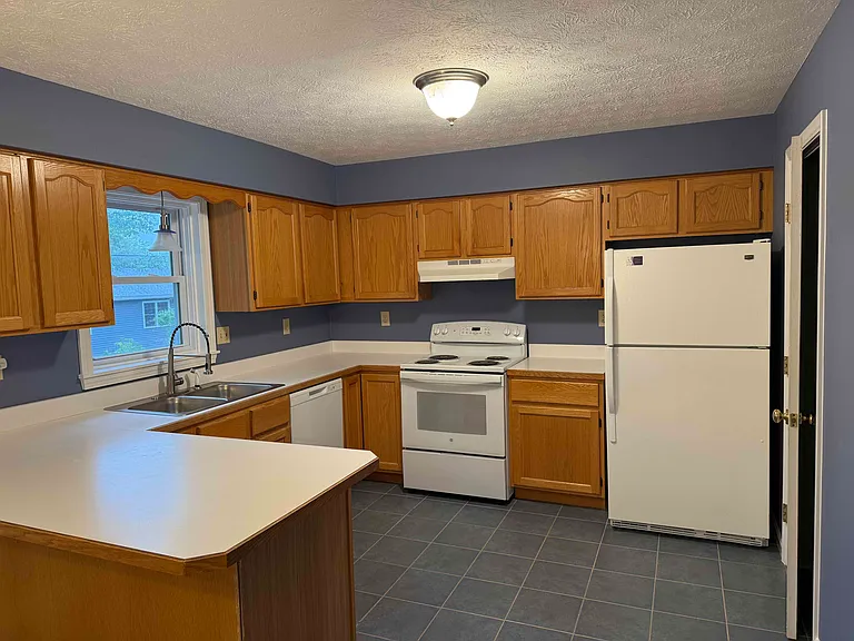 Good size kitchen, all appliances included: fridge, electric stove, dishwasher, garbage disposal. Half bath off kitchen