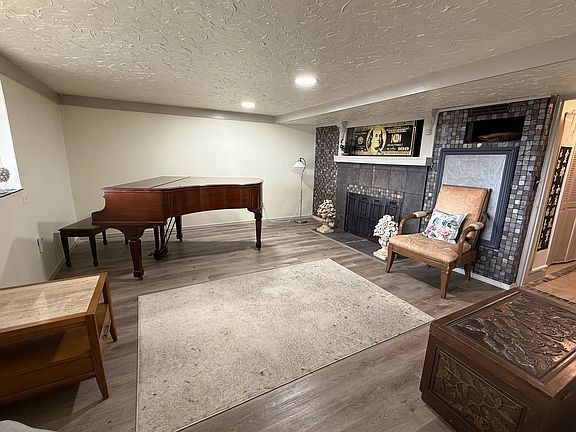 Fireplace, grand piano in this formal living space.