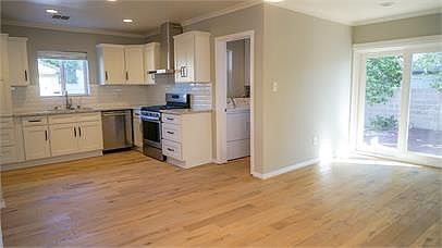 kitchen and dining room; view to laundry room, back yard