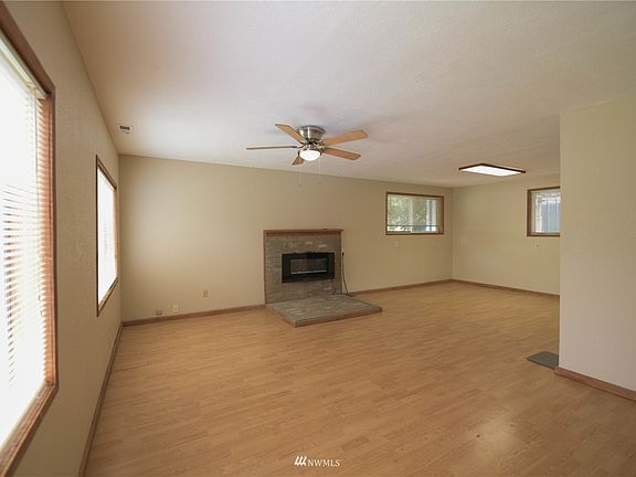 Family Room with Fireplace, Wood Floors, and Ceiling Fan>