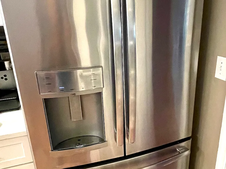 Refrigerator and freezer include external water and ice dispenser.