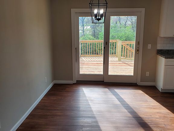 Formal dining room off the kitchen, sliding door to new deck.