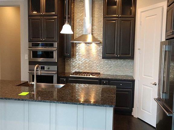 Upgraded custom kitchen colors and backsplash.