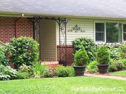 Front door, beds, & wrought iron detail