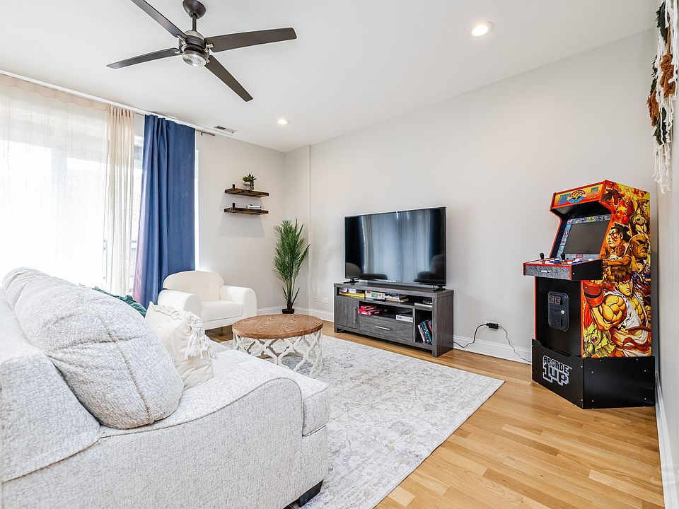 The cozy sitting area is appointed with a plush 3 person couch, an armchair, a 65" LED smart TV.