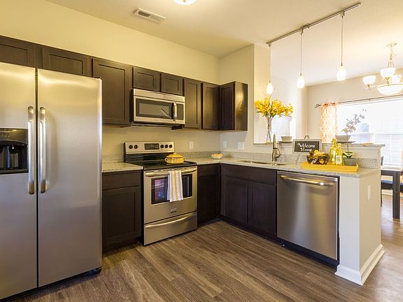Granite countertops, stainless steel appliances in this open