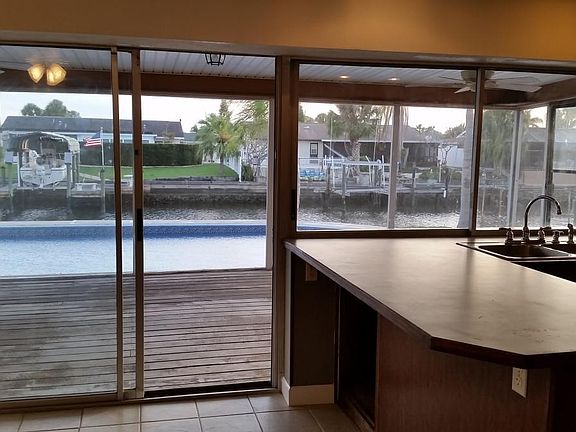 view of deck, pool, water pool from kitchen