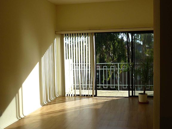 Top floor living room and balcony at sunset. Note the dimmable lighting and high ceilings.