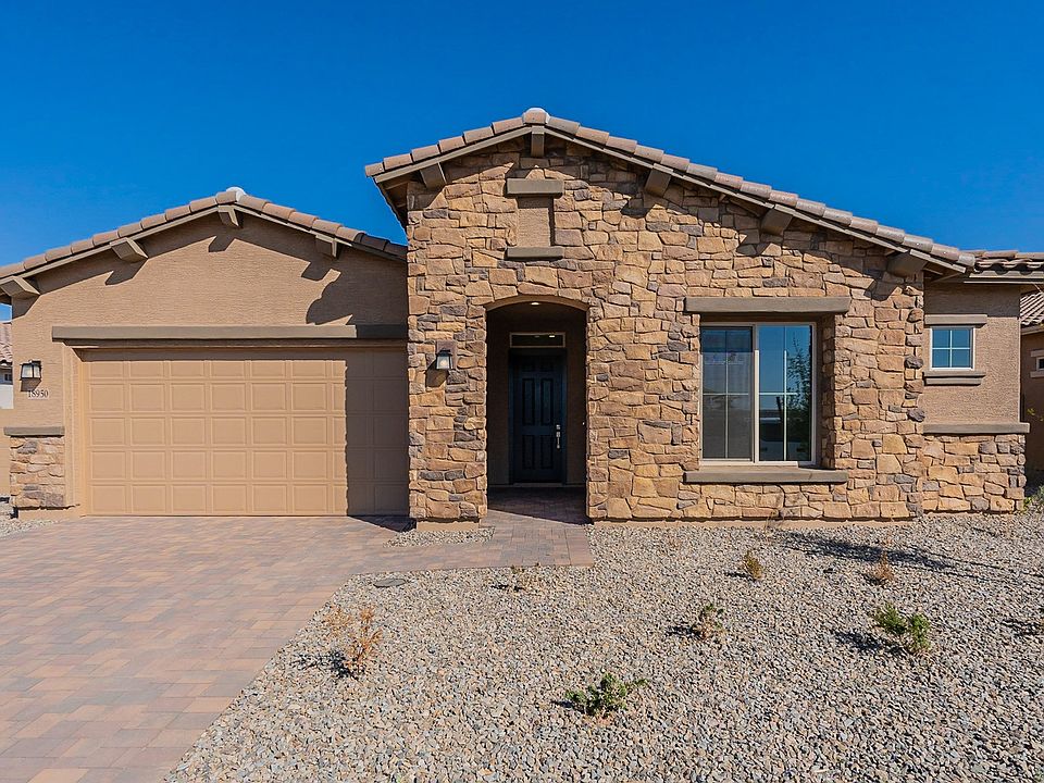 Exquisite stone facade with a sleek garage and elegant roofing, nestled in the prestigious Windrose