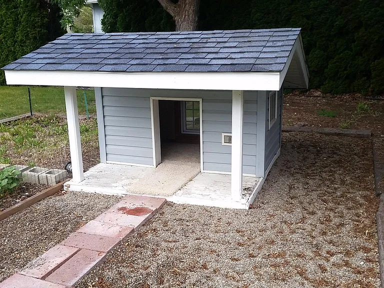 Heated and insulated dog house complete with carpet and wall A/C unit