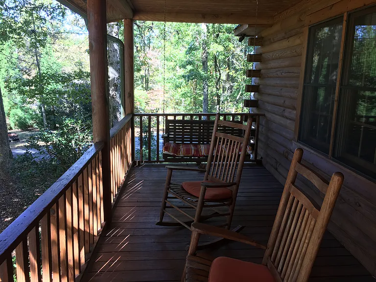 Front porch to relax on, with 4 rocking chairs and a porch swing