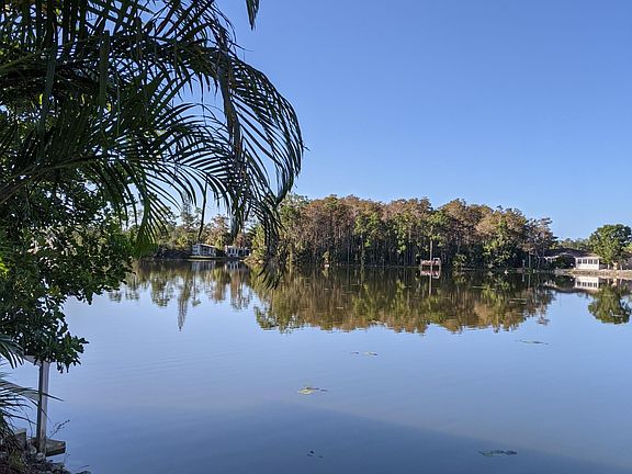 View across the lake from dining room, lanai and side patio