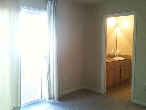 Downstairs bedroom with en suite bathroom & sliding glass ac