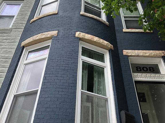 Front of home: Classic Bow front with cornice detail.