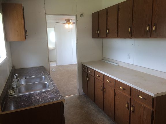 Newly Renovated Kitchen with new floor, cabinets, sink, and