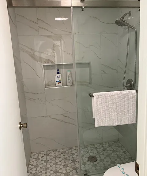 In suite bathroom shower . 
Bidet.