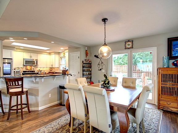 Large dining area with glass slider to fenced back yard with deck AND patio!