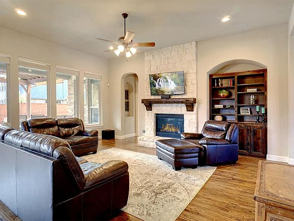 Spacious family room has a cozy floor to ceiling s