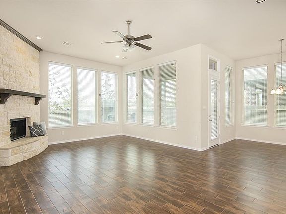 Home has beautiful wood flooring, stone fireplace, walls of windows, large kitchen, study and formal dining room.