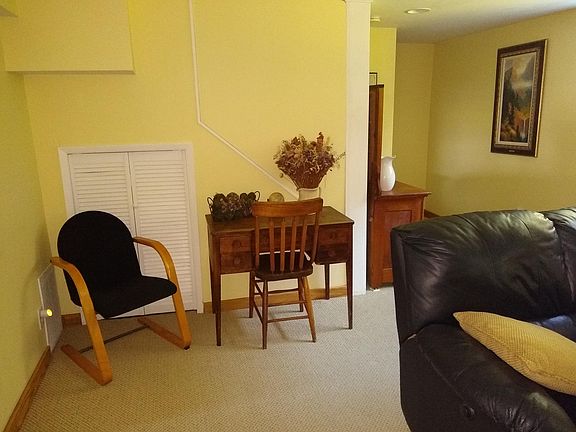 Antique desk for computer or work use; storage space under stairs.