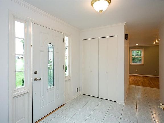 Spacious foyer with coat closet greets you upon entry.