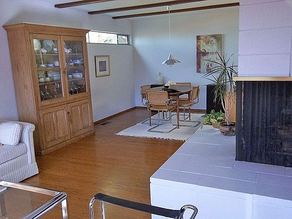 open-plan living/dining with two-sided fireplace