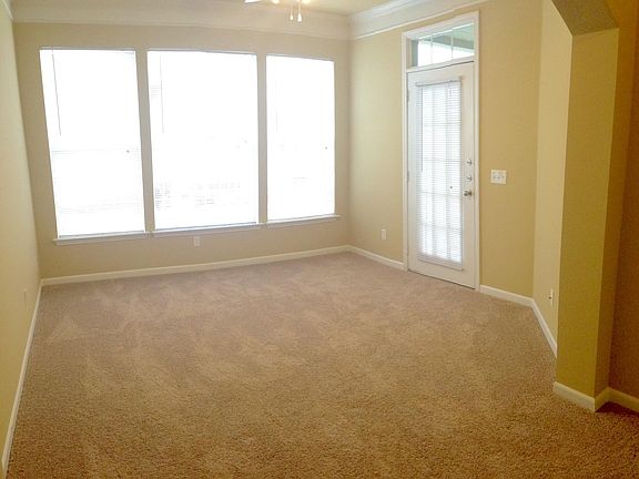 Plush carpet, and beautiful bay windows in the living room a