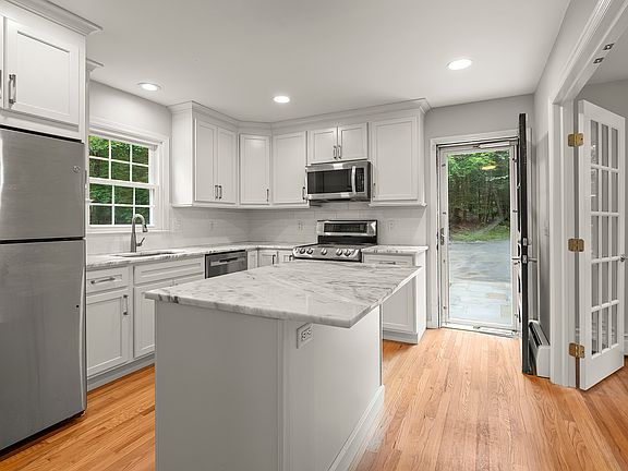 Kitchen with side door open, with flow to dining room