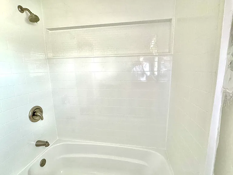 New bathroom Tub Surround, Vanity, Sink and Ceramic Tiled Floor