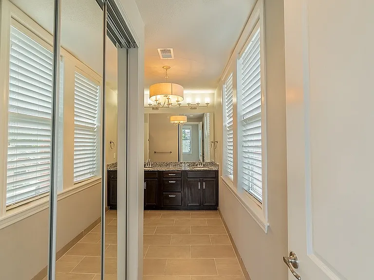 Bathroom Entrance and Mirrored Closet Space