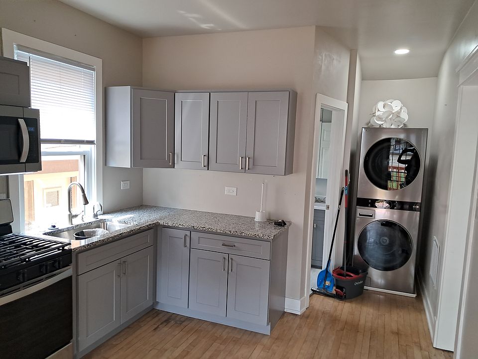 Kitchen with laundry room next to bathroom.