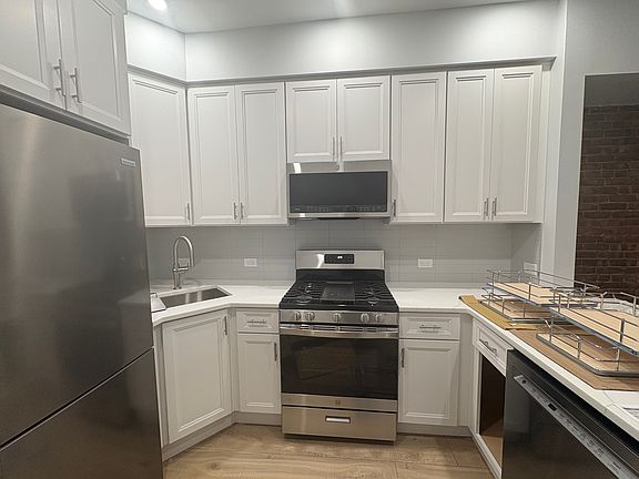 Kitchen. Solid Wood cabinets. All brand new GE appliances. Undercabinet lighting.