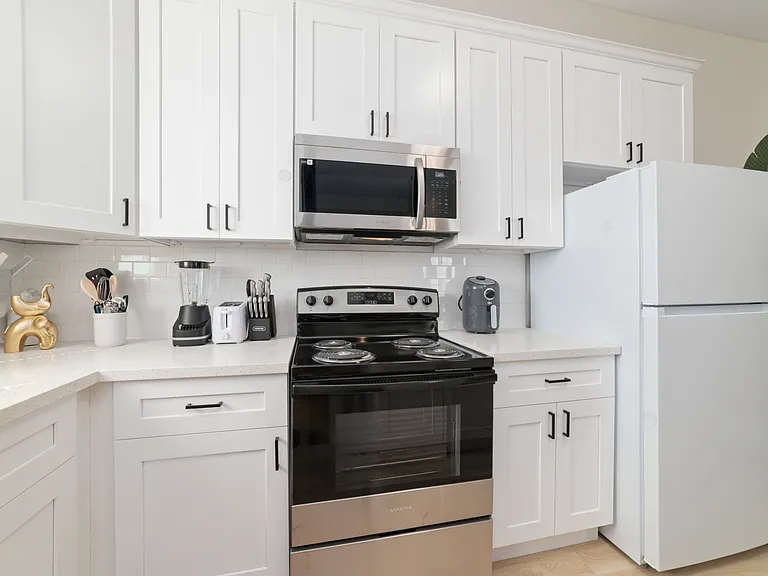 Several Cabinets, Full size Refrigerator/Freezer and needed utensils for cooking.