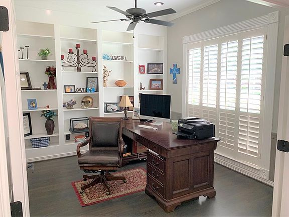 Tucked behind double French doors is the study complete with recessed lighting, custom built-ins, Plantation shutters and a breezy fan.