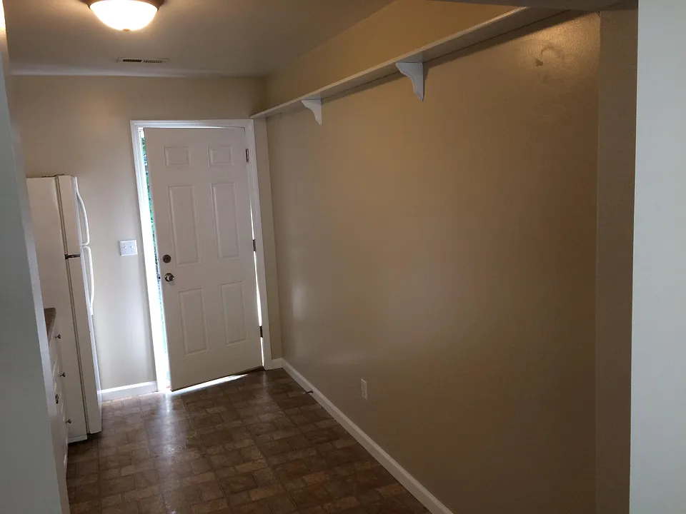 View From Living Room toward the back Door located in the Kitchen.