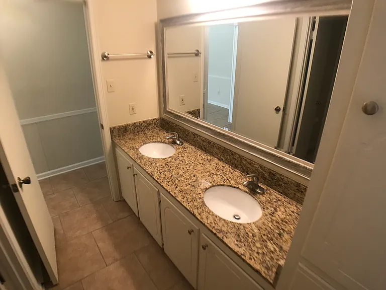 Hall Bath- Large Mirrow -Granite Countertops, new double sinks and faucets.
