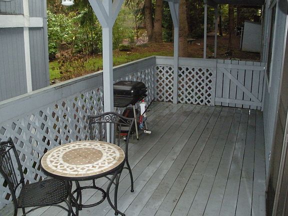 Large enclosed deck with gated entry to beautifully landscaped courtyard.