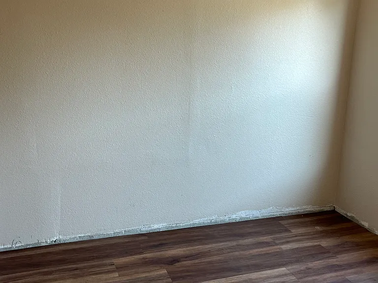 Bedroom 2. Please note the baseboard has been installed since the picture was taken.