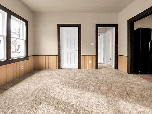 Kitchen is off to the right and you can see the second bedroom in back right corner. Open door in back middle leads to the flex room which could be a third bedroom or office. White door that is closed is the half bath that has the laundry hook ups.