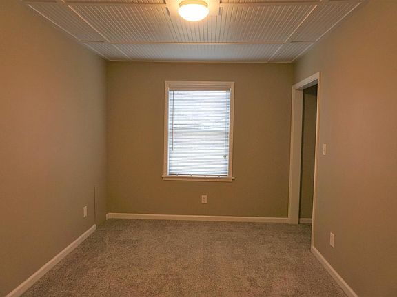 Bedroom with closet and nook for a dresser.