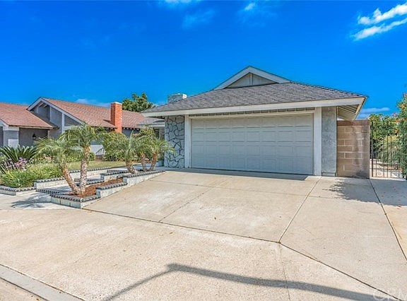 Two car garage with a mid size side yard to the right of the garage.
