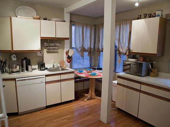 Kitchen with built-in seating behind table in corner.