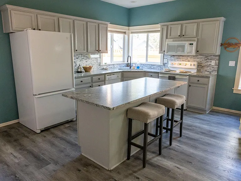 Fully updated kitchen. Note the fridge/freezer has been replaced with a larger stainless steel unit.