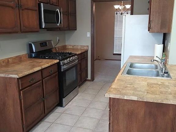 The kitchen has been updated with a new stainless steel refrigerator and a new kitchen faucet.