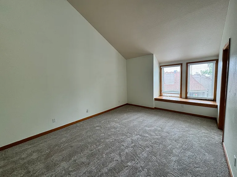 Generous primary bedroom with vaulted volume, natural light, and a quiet top-floor feel _ ideal as a calm private retreat.