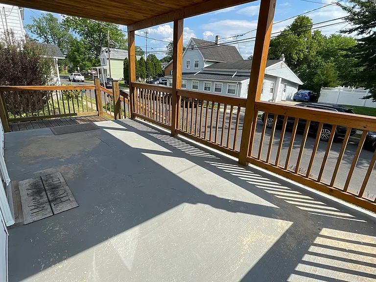 Spacious covered front porch. Perfect for relaxing, enjoying morning coffee, or unwinding at the end of the day.