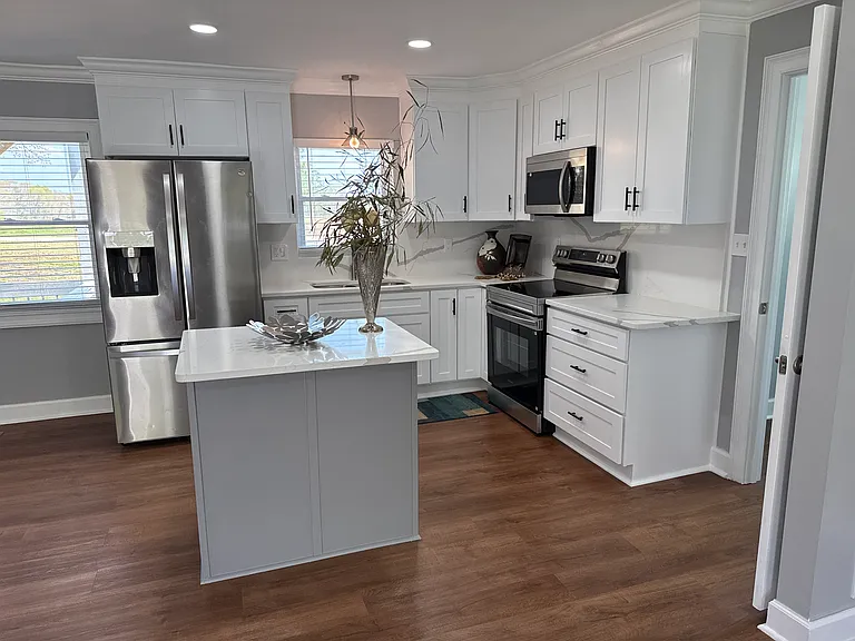 Fresh new kitchen with new range/oven, microwave, French door refrigerator with icemaker/water and bottom drawer freezer, new Corian counter tops with matching back splash, deep sink with garbage disposal, all new shaker cabinet.