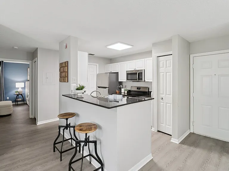 Stylish kitchen with breakfast bar seating and open-concept design Description: